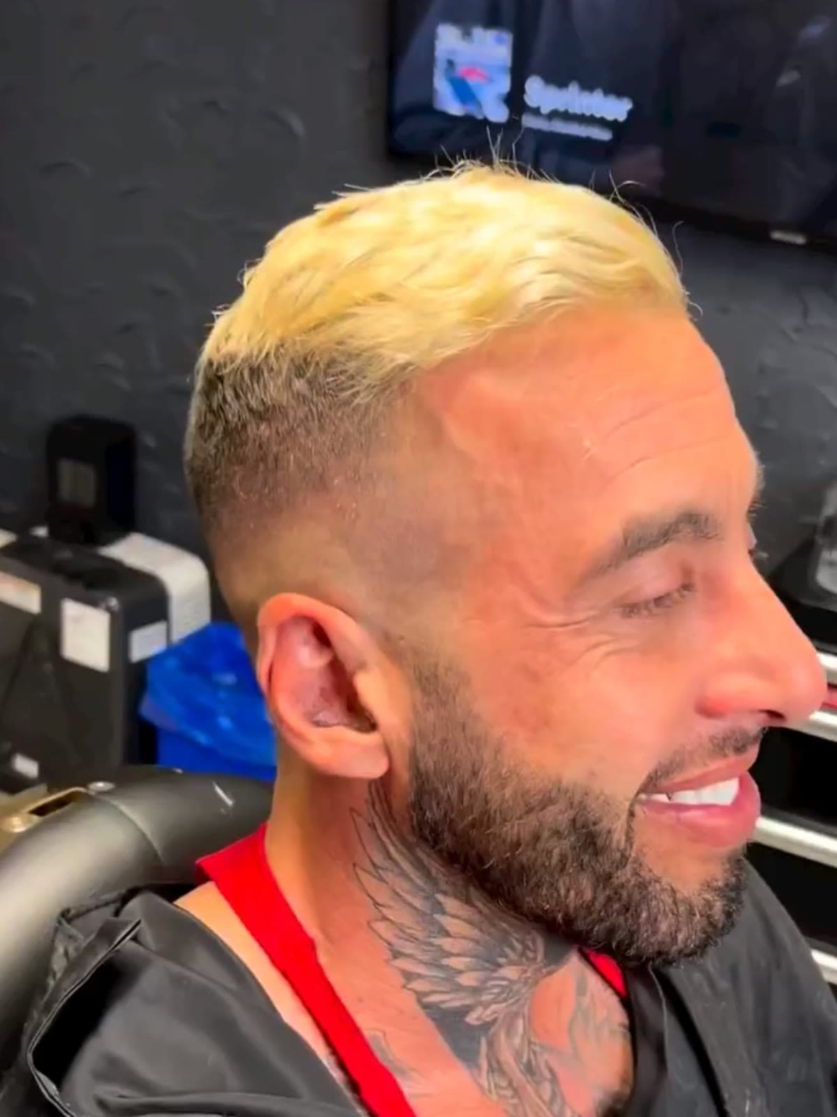 A bleached blonde crop over faded back and sides with a dark full beard