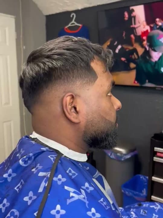 Finished mid fade blended from the temple with a sharp line-up and a shaped beard