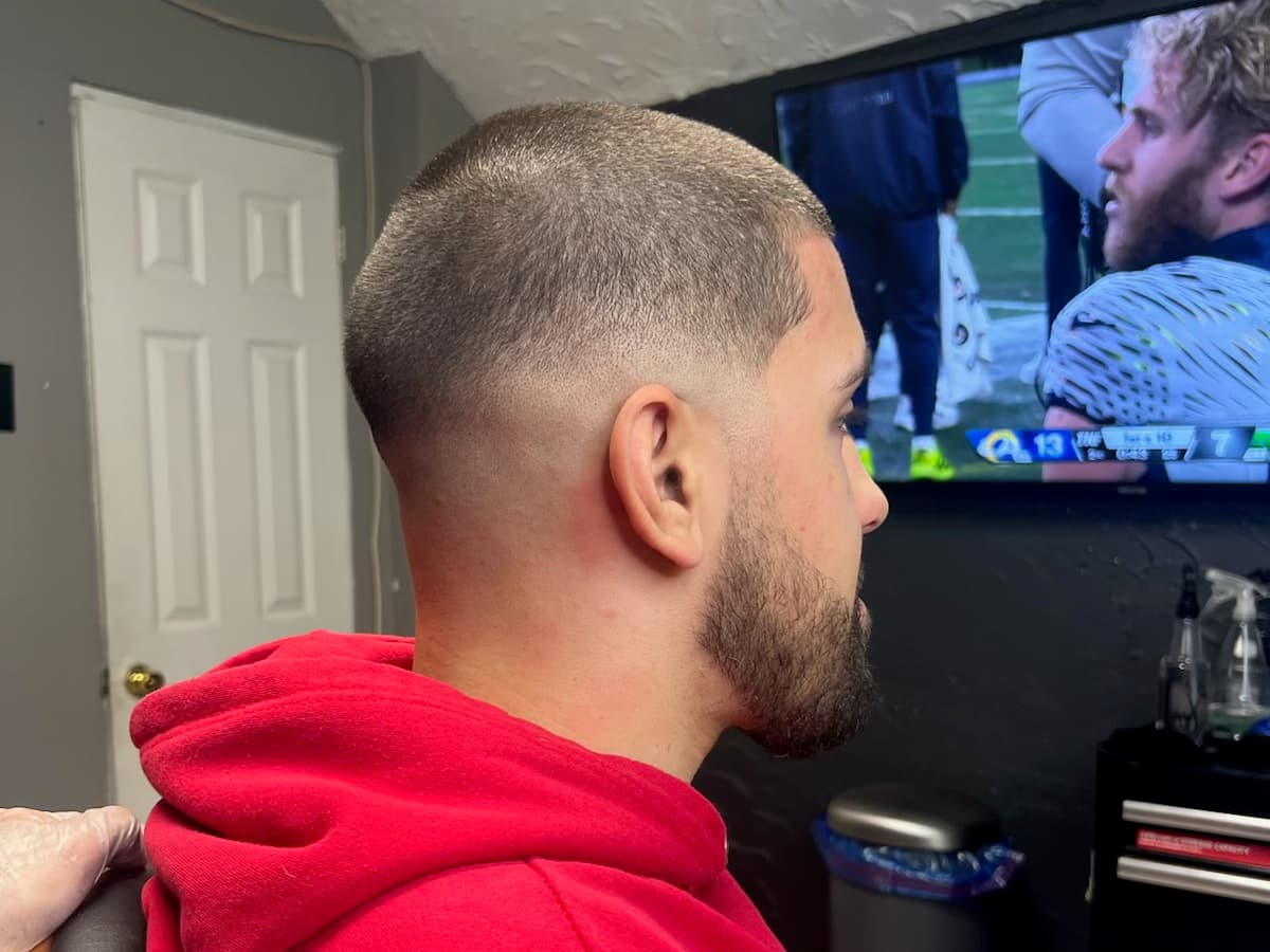 High skin fade blended out to nothing at the temple with the beard trimmed close